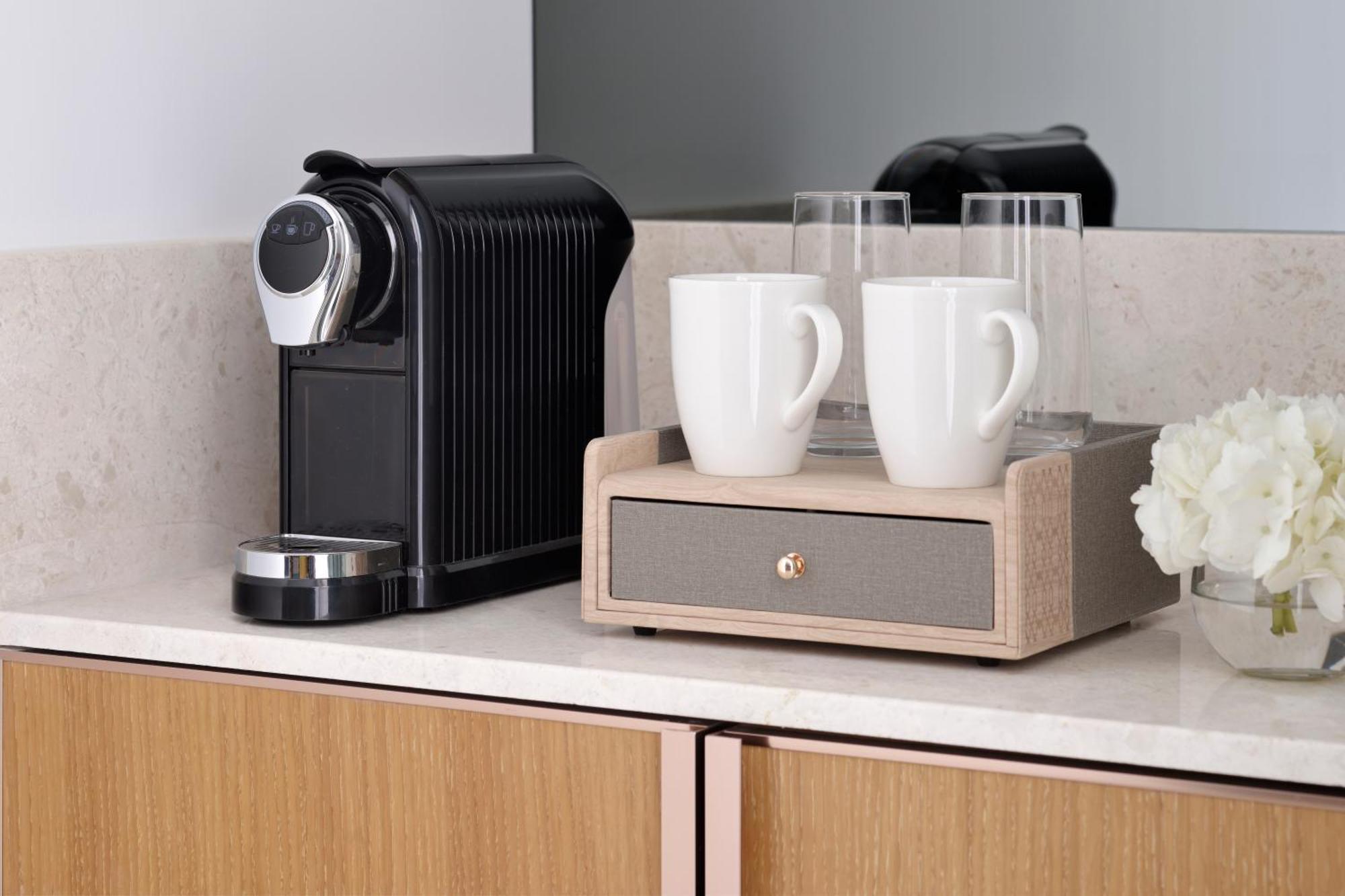 Moevenpick Hotel & Apartments Ghala Mascate Extérieur photo A Nespresso coffee machine